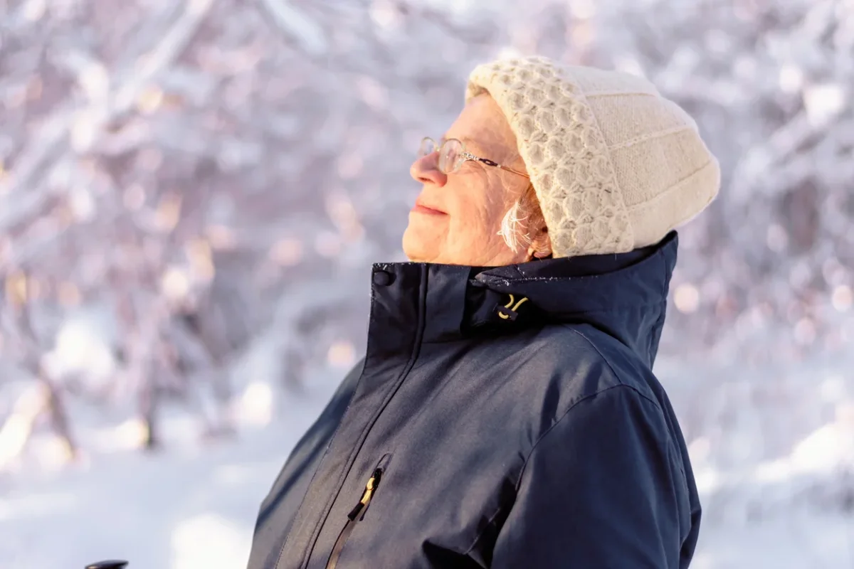 Senior woman enjoying a walk outdoors, illustrating normal forgetfulness vs dementia context in aging.